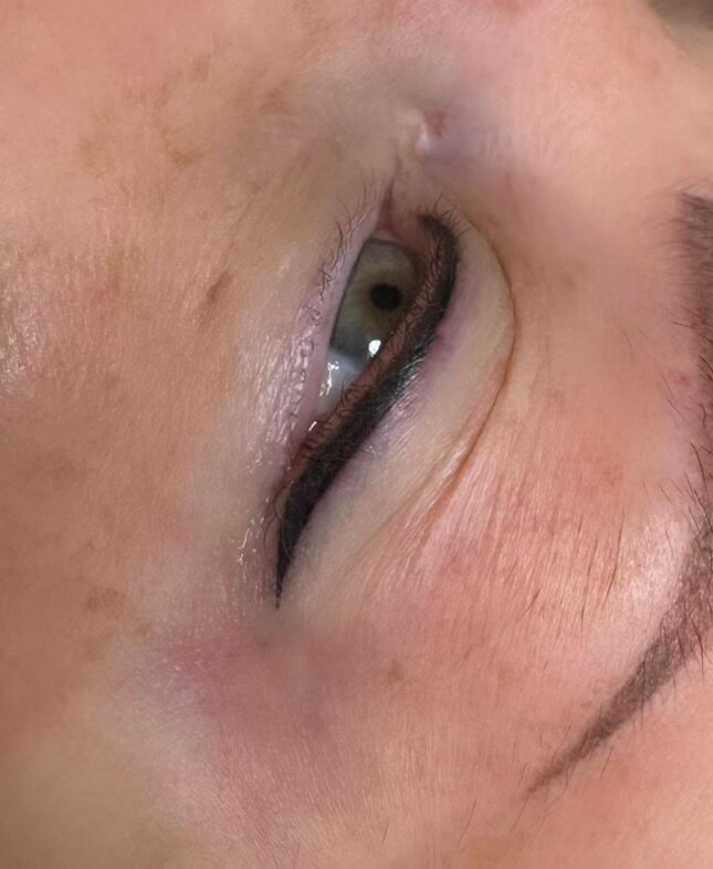 Fine permanent eyeliner on a closed-eye view